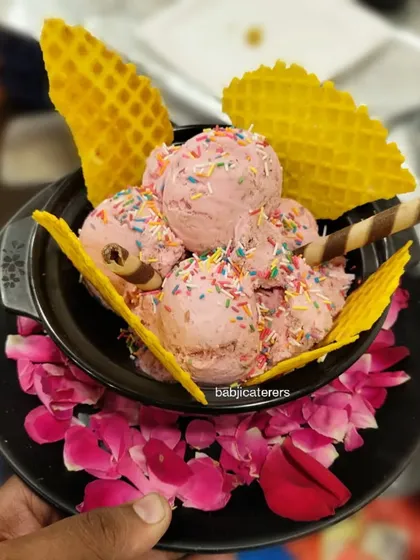 Our hand-churned Cashew Delight ice cream. This rich and nutty ice cream is served with crispy waffle biscuits for a delightful contrast in texture.