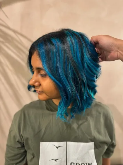 A side profile of the mermaid blue hair. The color is vibrant and fun, and the cut is modern and chic.