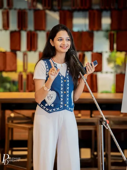 A young poet gestures expressively while performing. We are proud to be a platform where poets of all ages and backgrounds can find their voice.