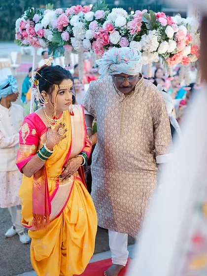 The bride's walk down the aisle, her Nauvari drape looking elegant and perfectly styled.