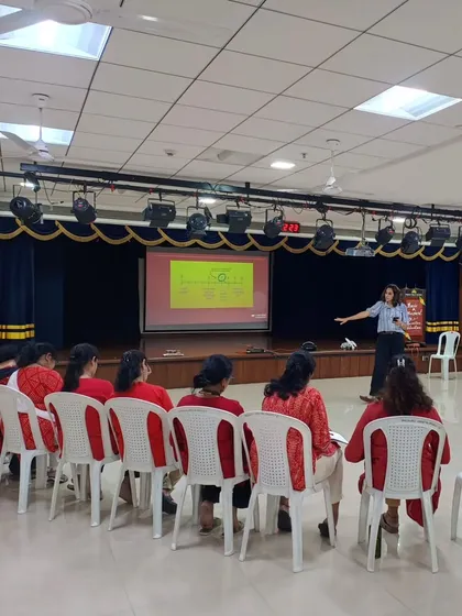 I am conducting a professional development session for a group of teachers in their school auditorium. My training provides a structured framework, complete with presentations and interactive modules, to help schools systematically adopt play based learning.