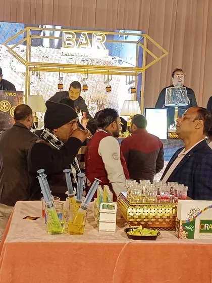Guests gathering at the bar to try the syringe shots. This setup shows how the shooter station becomes a social hub at the event.