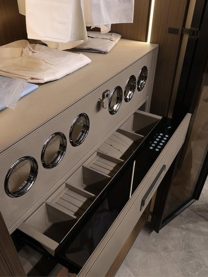 A close-up of a high-tech wardrobe feature: a drawer with a digital lock and specialized compartments. This highlights our ability to integrate modern technology and security into our custom wardrobe designs for ultimate peace of mind.