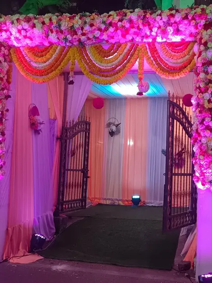 A beautiful floral gate decoration for Ashoka Banquet hall in Vashi. The combination of pink flowers and traditional marigold garlands makes for a classic and festive wedding entrance.