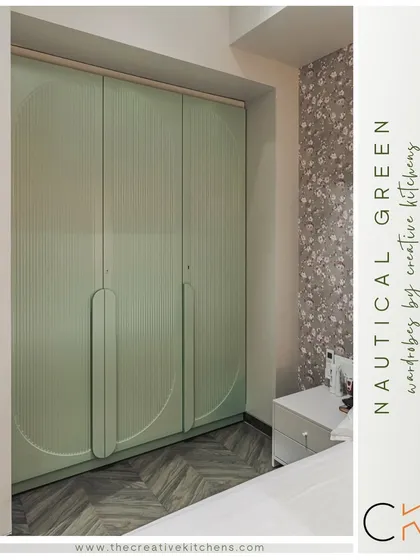 This nautical green wardrobe brings a refreshing touch to the bedroom. The fluted shutters and curved handle design, finished in a sophisticated European membrane, offer a unique and opulent look.