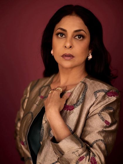 This pose showcases the regal elegance of the brocade jacket, paired with statement Tyaani jewelry.