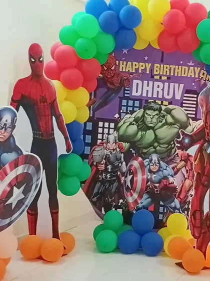 A detailed look at the colorful balloon arch and superhero cutouts for the Avengers theme.