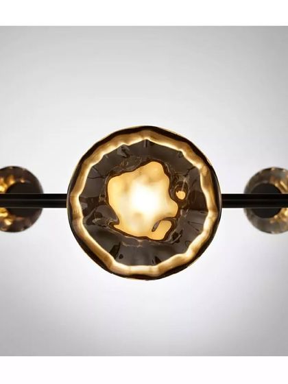 A close-up of a Ceto glass shade, its surface beautifully capturing and refracting the light, reminiscent of the sun on water.