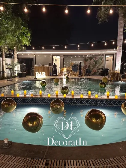 For a fabulous 40th birthday, we transformed this poolside into a chic, modern oasis. The combination of string lights, floating golden orbs, and warm candle lighting created an unforgettable ambiance for an adult celebration.