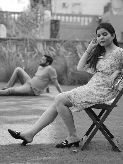 A chic black and white shot from a garden pre-wedding session, capturing a candid and relaxed moment.