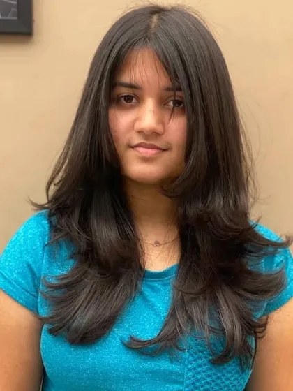 A frontal view of a client's new layered haircut, a style that is both modern and flattering.