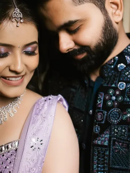 A close-up of the couple in a loving embrace. The bride's sparkling makeup and the groom's soft smile create a portrait that is both glamorous and deeply personal.