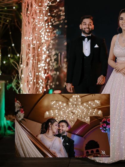 A creative shot where the couple holds a framed photo from their own engagement shoot.