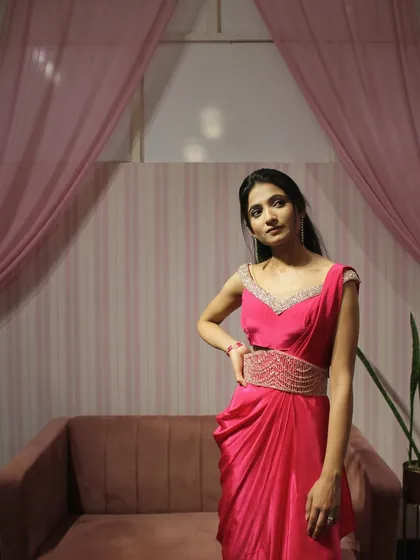 The pink draped saree is perfect for a daytime wedding or a cocktail party.