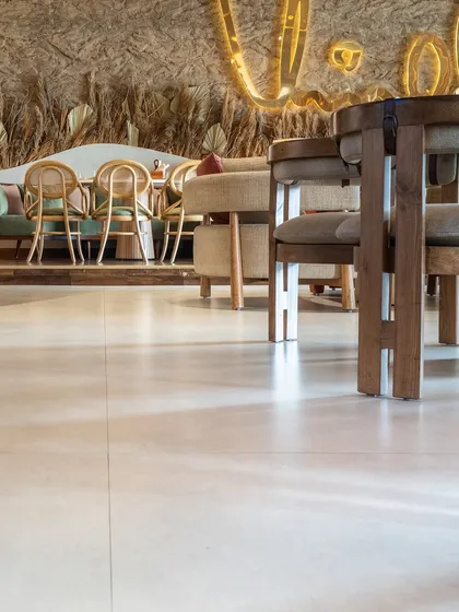 Another perspective of the clean, large-format floor tiles at One 8 Commune, providing a neutral base that allows the restaurant's other design elements to stand out.