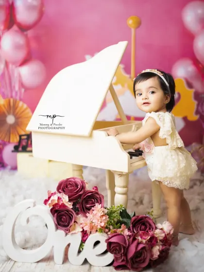 Standing at her piano, this one-year-old is ready to play a birthday tune. I love creating these imaginative scenes to celebrate your baby's unique personality.