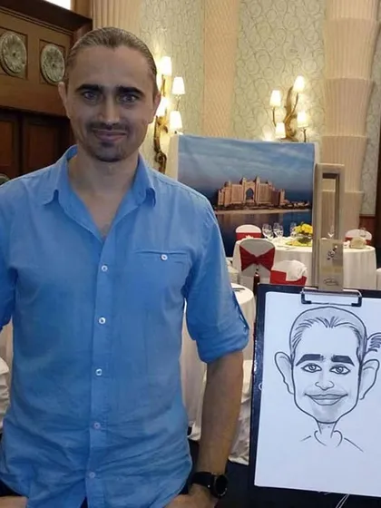 Here I am with my drawing board at a formal event. I can set up my station in any corner to provide entertainment for guests.