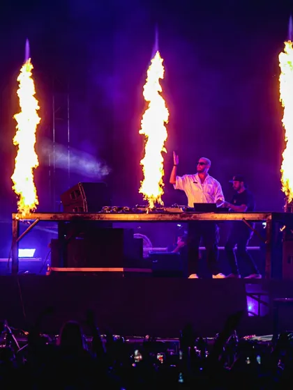 DJ Snake commands the stage with three massive jets of fire erupting in front of him.