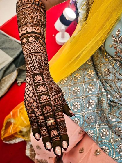 This bridal design is filled with repeating lotus patterns, creating a beautiful and symbolic look for the bride.