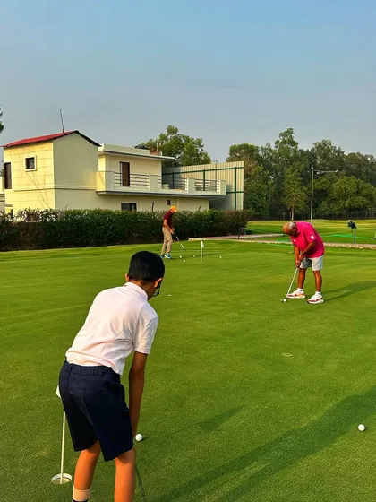 Young golfers learning the ropes on the putting green, a great way to build a solid foundation.