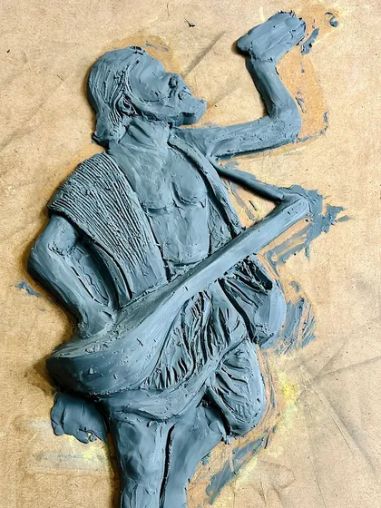 Here is the raw, unpainted clay sculpture in progress. You can see the form taking shape as I build up layers of clay to create the figure.