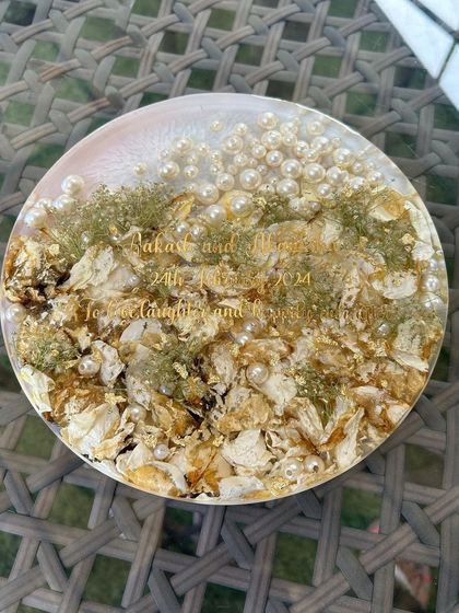 Another view of the 8-inch varmala preservation frame. The combination of preserved flowers, pearls, and gold flakes creates a rich and luxurious look.