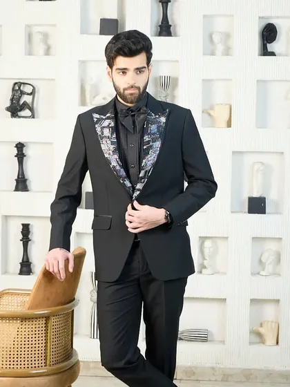 This black tuxedo with a patterned lapel offers a unique twist on formal wear, perfect for the gentleman who wants his personality to shine through his style.