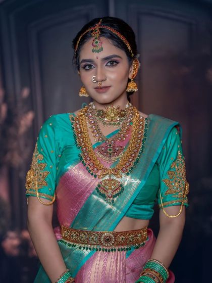 A closer view of the teal and pink saree look, highlighting the layers of antique gold jewellery and the flawless makeup base.