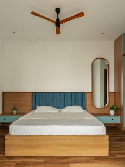 The 'Bodhisatwa' residence in Tumkur features a minimalist bedroom with clean lines, a simple color palette, and functional built-in furniture.
