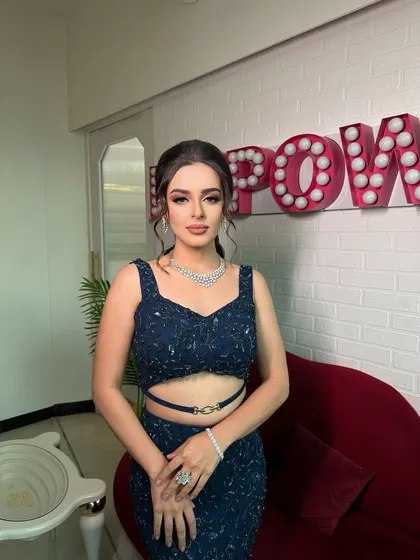 A direct look at the camera, showcasing the precision of the soft glam makeup. The eyes are the focus, with a clean, blended look that is both modern and timeless.