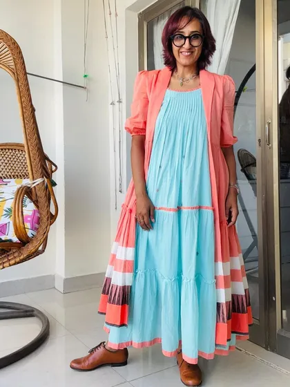 The full outfit, showing the flow of the tiered dress. The color combination of light blue and coral is so refreshing.