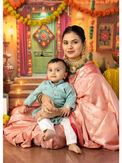 A mother's gentle embrace. This portrait of a mother and her child in their festive best is a timeless capture of love and tradition.