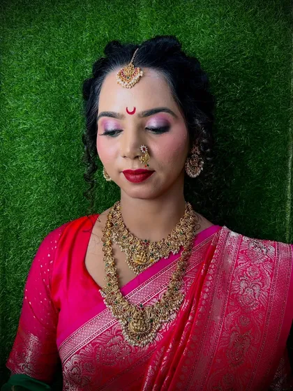A South Indian inspired bridal look with temple jewelry and a classic red lip. We encourage students to explore and master various regional bridal styles.
