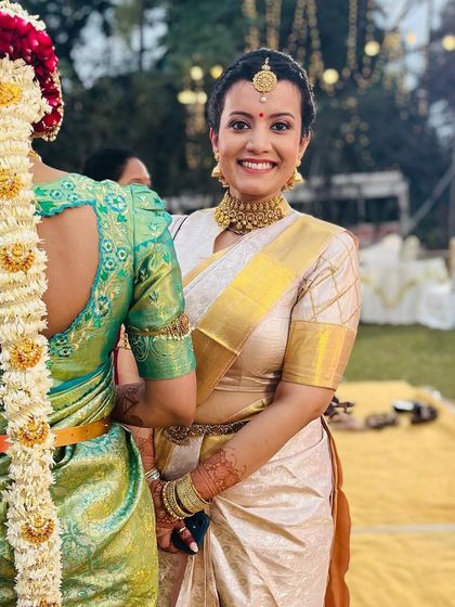 A smile that lights up the world. This candid shot captures the joy of a wedding celebration. I created a classic, elegant South Indian look for her to wear as a guest.