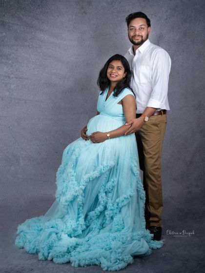 A classic and elegant full-length portrait of the couple. Her flowing blue gown adds a touch of romance to the scene.