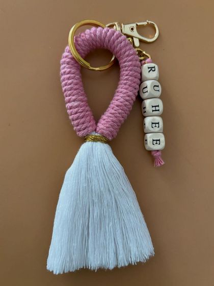 A close-up of the personalized tassel keychain. This one is a lovely combination of pink and white.