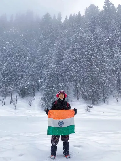 That feeling of accomplishment on the Kedarkantha summit. This winter trek is famous for its stunning 360-degree views of snow-capped peaks.