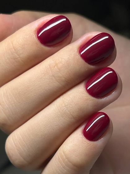 A classic, deep red manicure on short, rounded nails. The color is rich and the application is perfectly clean, showcasing our signature Russian manicure.