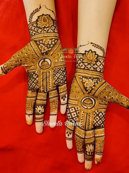 A traditional design for guests featuring bold check patterns and symbolic 'darpan' (mirror) motifs.