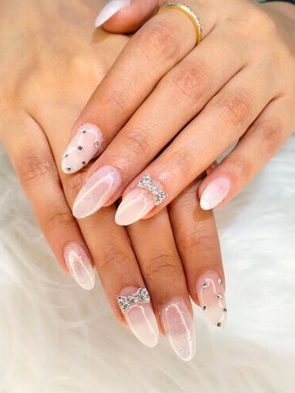 A delicate and feminine design featuring a sheer white ombré base, accented with sparkling 3D rhinestone bows and scattered gems.