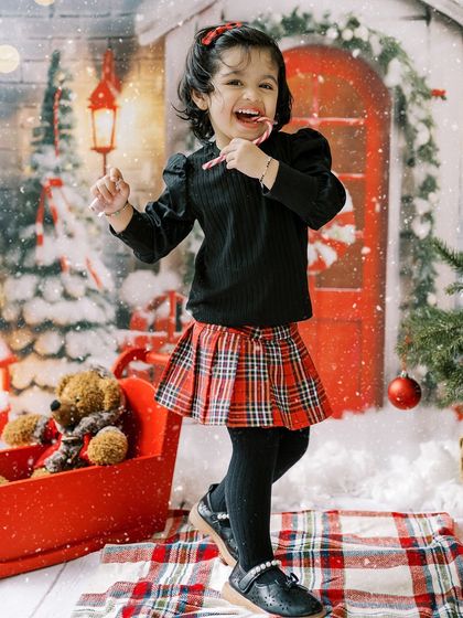 A little girl dancing with a candy cane. The joy and energy of the holidays are perfectly captured in this fun, festive shot.