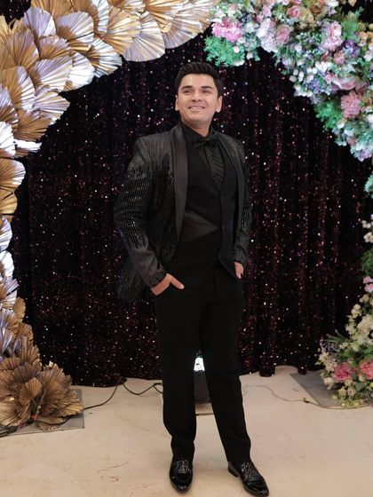 Posing for a photo at his engagement party, our client looks completely at ease and stylish in our rental tuxedo. My goal is to make you look great so you can focus on enjoying your moment.