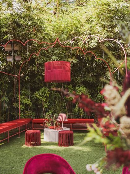 Another angle of the "Red Affair" lounge, showing the unique hanging fabric chandelier that centers the space.