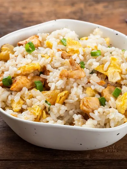 A simple and classic chicken fried rice. The clean styling and wooden background make it a versatile image for any Pan-Asian menu.
