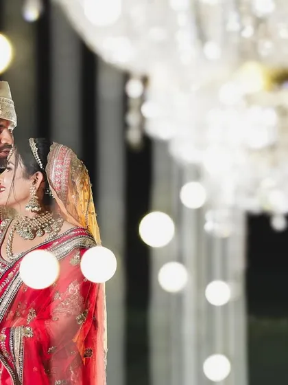 A beautiful, intimate portrait of the couple, with the bokeh from crystal chandeliers creating a dreamy, romantic background.