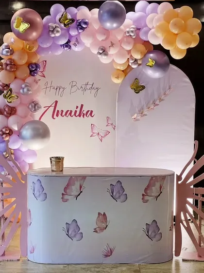 This whimsical butterfly theme is perfect for a magical birthday. It features a pastel balloon arch, custom-printed table, and large, elegant butterfly wing cutouts that make for a beautiful photo opportunity.
