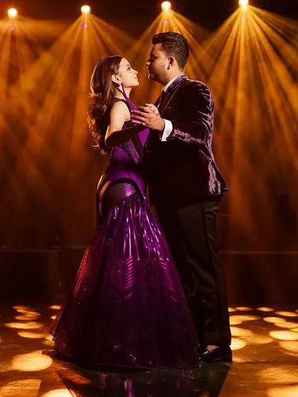 A magical moment from the masquerade ball. The bride's structured purple Amit Aggarwal gown and the groom's custom velvet tuxedo create a look of pure enchantment.