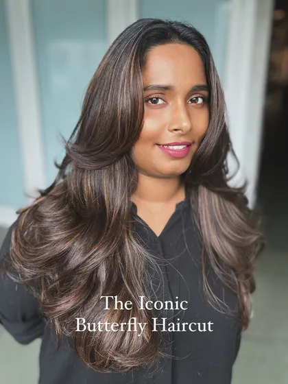 The iconic butterfly haircut is one of the most requested styles today. This image shows the beautiful, face-framing layers and incredible volume that this cut creates, a key focus of our online workshops.