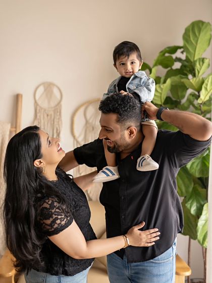 A father gives his son a shoulder ride. This classic, playful pose always results in the best smiles and captures the fun-loving relationship between a dad and his child.