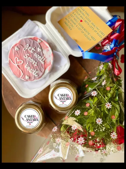 The perfect way to send some cheer. This "get well soon" package includes a personalized bento cake, two comforting cake jars, a beautiful bouquet of fresh flowers, and a handwritten note to lift their spirits.